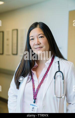 Portrait of confident female doctor standing in hospital Stock Photo
