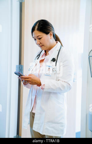 Asian female doctor using phone and tablet for medical consultation in ...