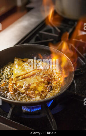 High angle view of crepes being fried in pan Stock Photo