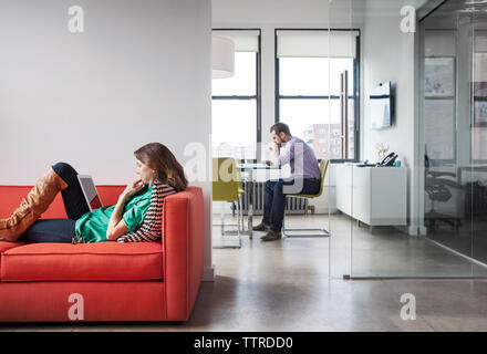 Side view of business people working in creative office Stock Photo