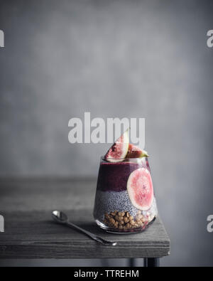 Close-up of drink with spoon on wooden table Stock Photo