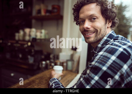 Side view portrait of happy man sitting at cafe Stock Photo