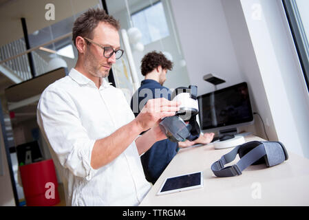 Male technicians working at table in office Stock Photo