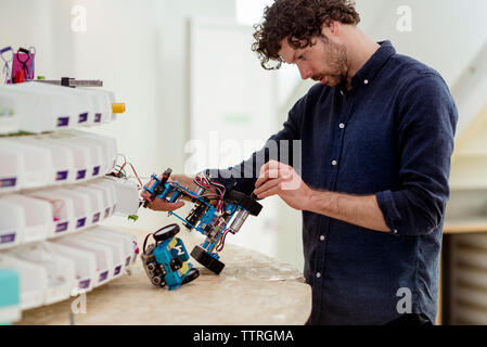 Engineer making drone at table in office Stock Photo