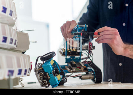 Midsection of engineer making drone in office Stock Photo