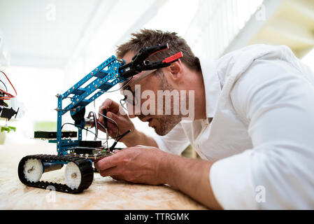 Engineer examining drone at table in office Stock Photo