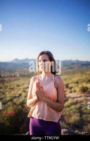 Side view of woman feeding deer Stock Photo