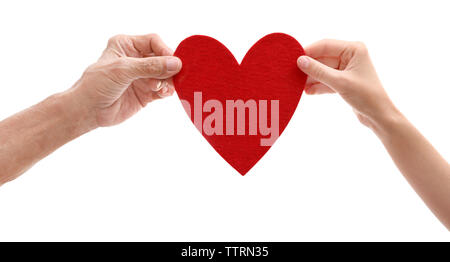 Old male and young female hands with heart figure on white background Stock Photo