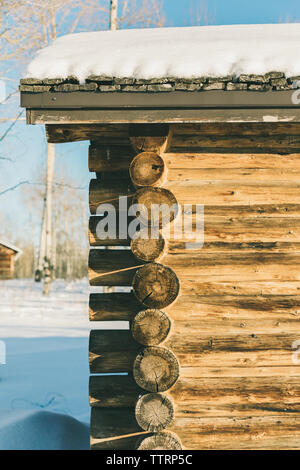 Snow covered old historic log cabin on a sunny day Stock Photo