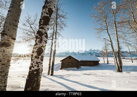 Cabin sits along in a winter wyoming near the grand teton mountains Stock Photo