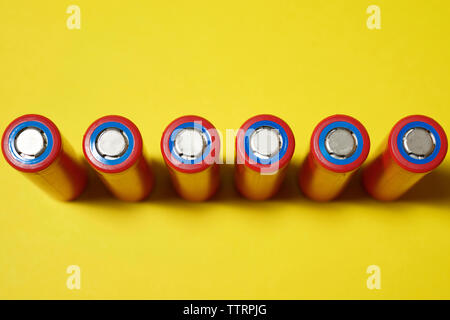 High angle view of batteries on yellow background Stock Photo