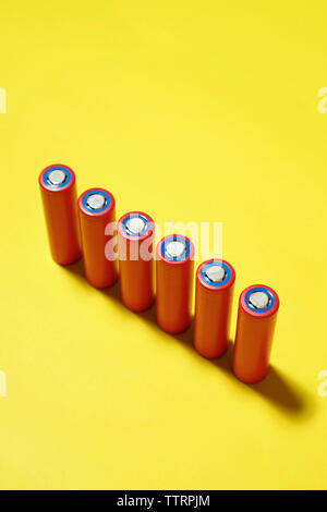 High angle view of batteries on yellow background Stock Photo