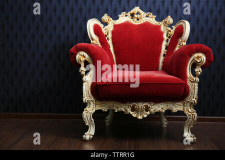 Luxury red armchair on dark background Stock Photo - Alamy