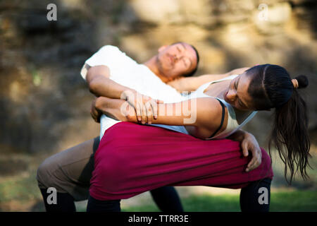 Affectionate couple embracing while practicing dance on field Stock Photo