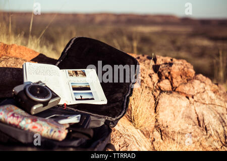 High angle view of camera with personal accessories on rock Stock Photo