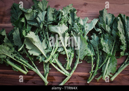 Close-up of fresh turnip leaves on wooden table Stock Photo