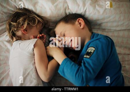 brother and sister smiling and laughing having fun at home. siblings Stock Photo