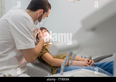 Dentist examining patient's teeth in medical clinic Stock Photo