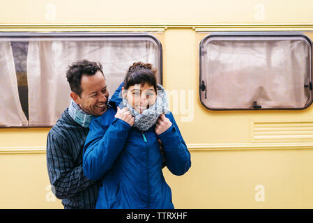 Mid adult couple hugging while standing outdoors Stock Photo