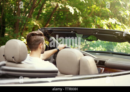 Man driving car on road trip Stock Photo