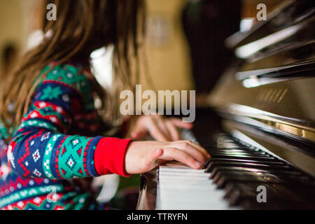 Close up of girls hand playing piano