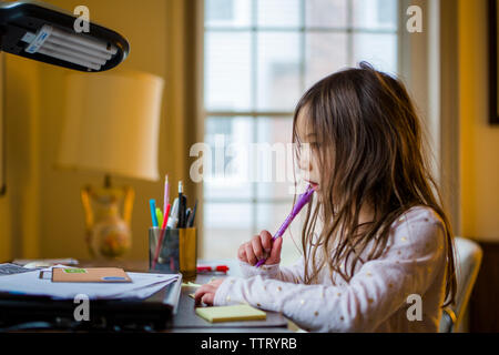 little multi ethnic girl doing school work at home Stock Photo