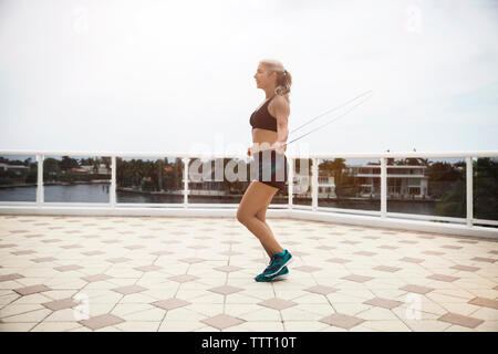 A Senior Woman with Sports Bra Outdoors on a Terrace in Summer, Exercising.  Stock Photo - Image of retired, exercise: 165544722