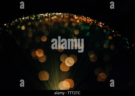 Abstract image of illuminated fiber optics against black background Stock Photo