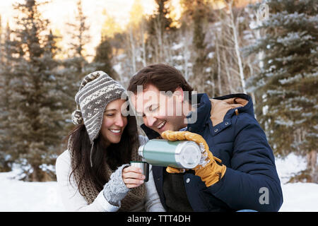 Man pouring coffee for wife in cup Stock Photo