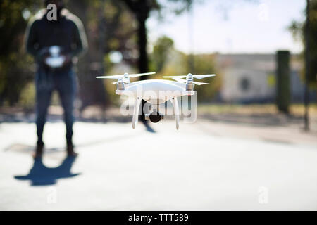 Close-up of drone operated by man in basketball court Stock Photo