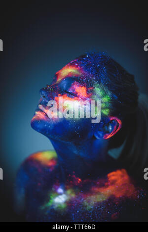Conceptual shot of light and shine fluorescent colors young girl's face Stock Photo