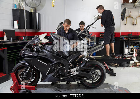workers making motorbikes in factory Stock Photo