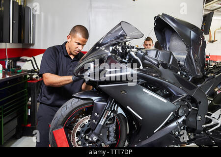 workers making motorcycle in factory Stock Photo