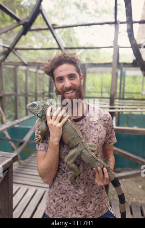Man holding Iguana Stock Photo