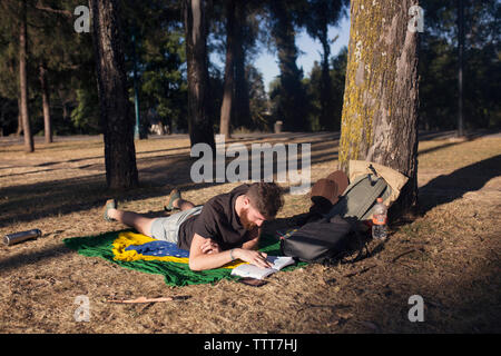Man reading a book in a park Stock Photo