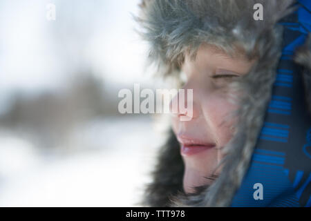 Boy breathing fresh air in winter wonderland Stock Photo