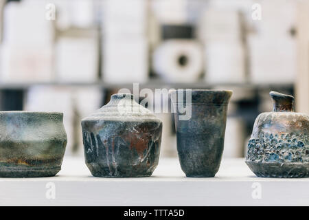 Close-up of earthenware on table at workshop Stock Photo