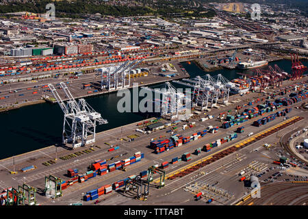 Aerial view of cargo containers and cranes at commercial dock Stock Photo