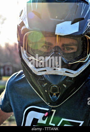 Portrait of young man wearing crash helmet Stock Photo