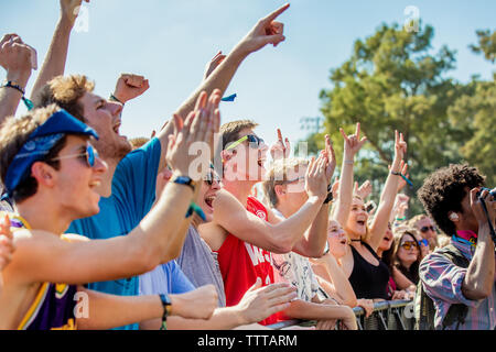 Happy Fans Attending The Voodoo Music and Arts Experience Stock Photo