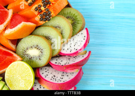Juicy exotic fruits on blue wooden background Stock Photo