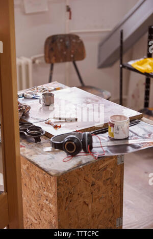 High angle view of wood with headphones and watercolor paints on table Stock Photo