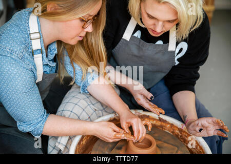 Women working on pottery wheel in workshop Stock Photo
