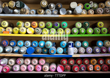 Close-up of spray paints arranged on shelves Stock Photo