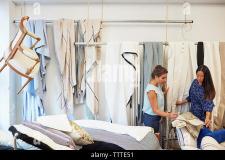 Interior designers selecting curtain samples in workshop Stock Photo