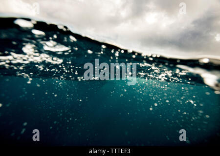 A split level underwater view of rough ocean with cloudy skies Stock Photo