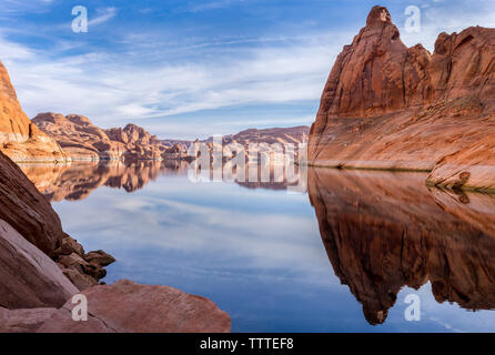 Red rock cliff reflection on water of Lake Powell Stock Photo