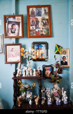 JAMAICA, Port Antonio. Family photos on a wall inside a local home. Stock Photo