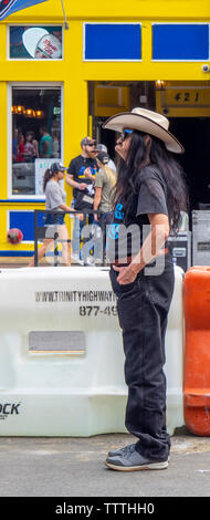 Elderly man with long hair standing on Broadway during NFL Draft 2019 Nashville Tennessee. Stock Photo