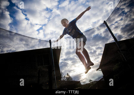 Front view of girl jumping on a trampoline
